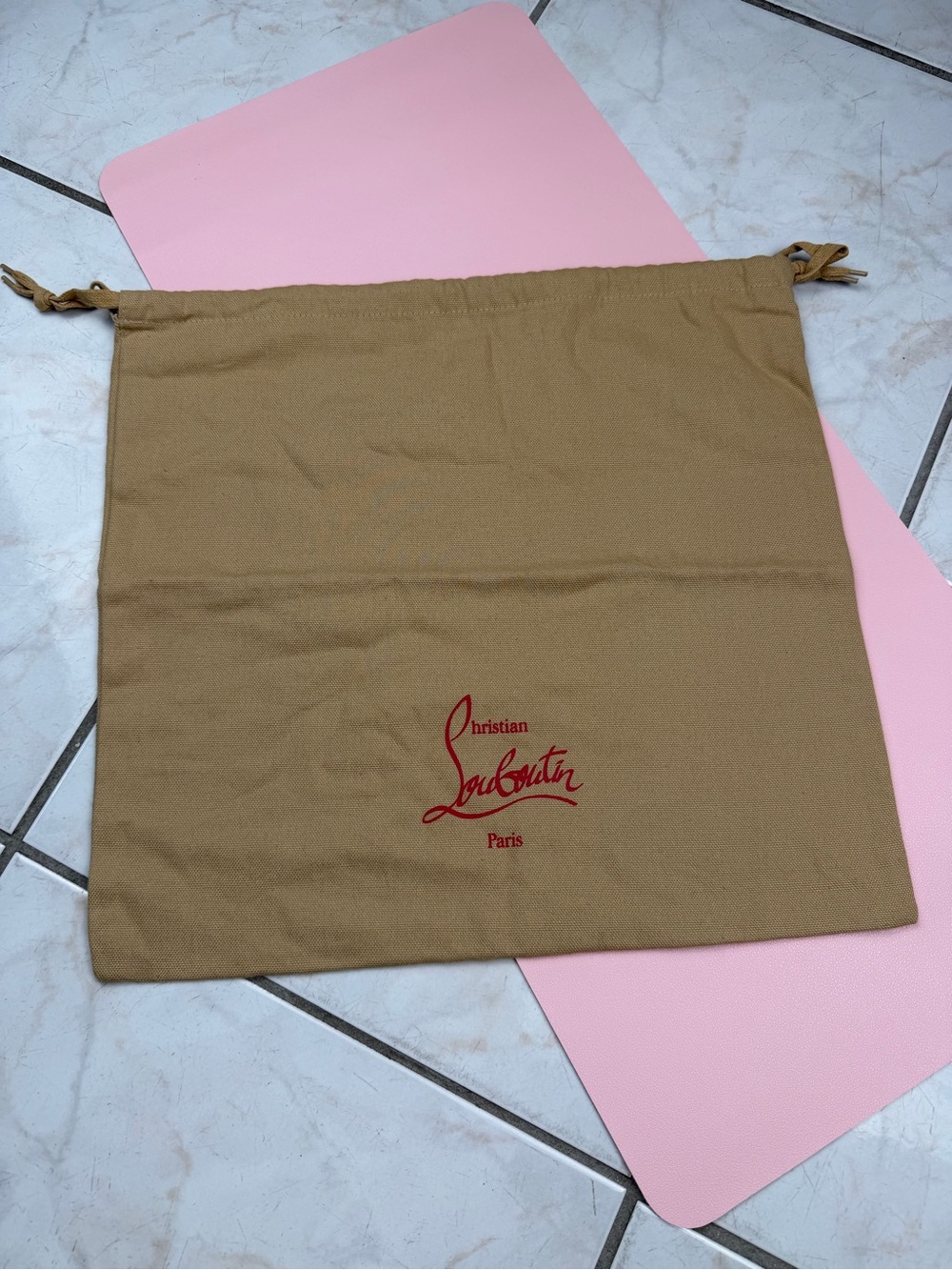 Christian Louboutin tan dust bag with red logo